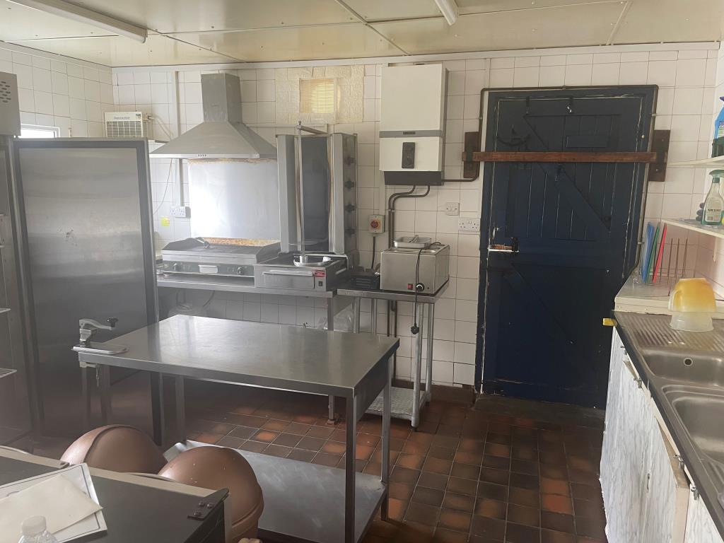 Lot: 91 - DETACHED COMMERCIAL PREMISES - Commercial kitchen with door leading to side area of hardstanding